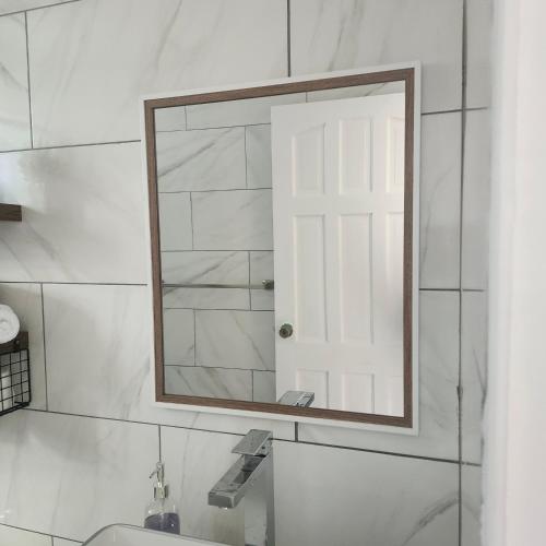 a mirror on a wall above a sink in a bathroom at Belle View Haven in Canefield