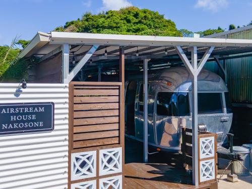 a building with a van parked inside of it at Air Stream House Nakasone in Nakijin
