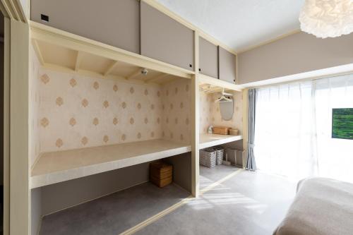 a room with a bed and a desk at Beige Frame in Tokyo