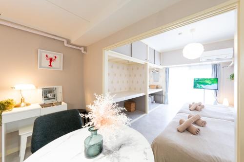 a bedroom with a bed and a table in a room at Beige Frame in Tokyo