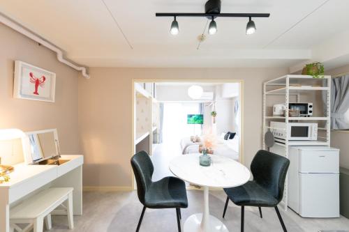 a room with a table and chairs and a bedroom at Beige Frame in Tokyo
