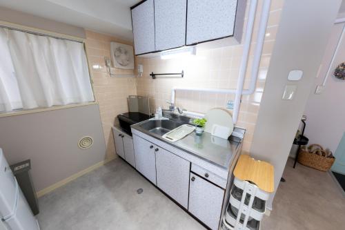 a small kitchen with a sink and a counter at Beige Frame in Tokyo