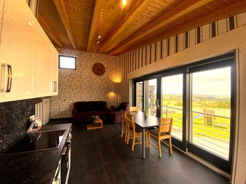 a kitchen and dining room with a table and chairs at Wohnung In Schmidt Mit Grill Und Garten in Nideggen