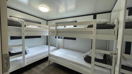 a room with three bunk beds in a room at Tasman Holiday Parks - Yallingup Beach in Yallingup