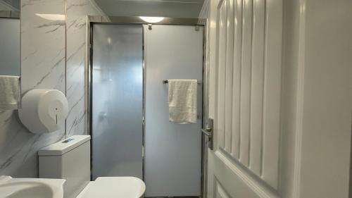 a white bathroom with a shower and a toilet at Tasman Holiday Parks - Yallingup Beach in Yallingup