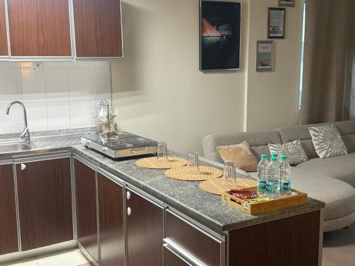 a kitchen with a counter with drinking bottles on it at Suite one bedroom apartment Down town abudhabi in Abu Dhabi