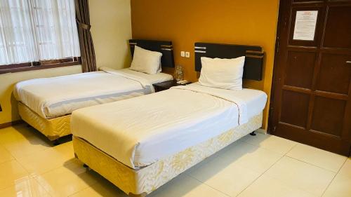 Un ou plusieurs lits dans un hébergement de l'établissement Hommy Inn Timoho