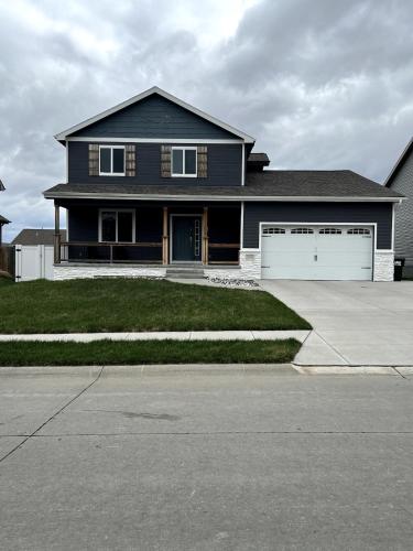 a large blue house with a white garage at Blue Diamond Dream in Bennington