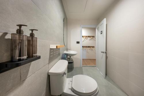 a bathroom with a toilet and a sink at Ralph Poshtel Sukhumvit in Bangkok
