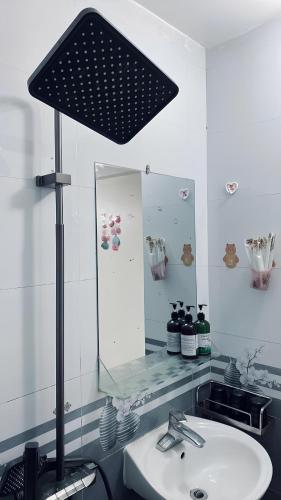 a bathroom with a sink and a large mirror at Gem Hostel in Cat Ba