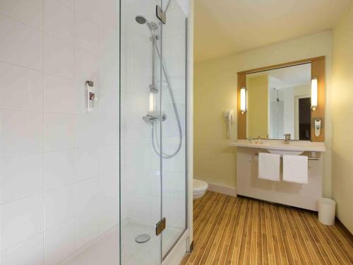 a bathroom with a shower with a toilet and a sink at ibis Lille Lomme Centre in Lomme