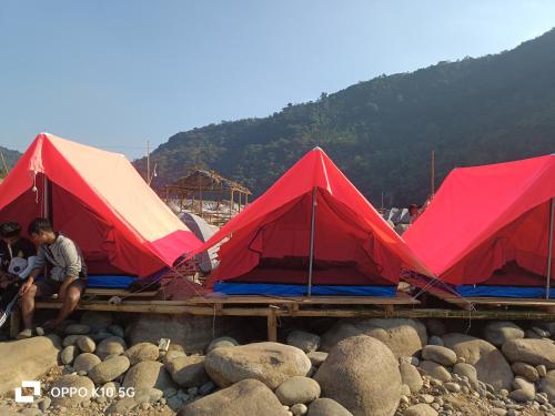 a group of tents on a pile of rocks at Front view campsite in Shillong