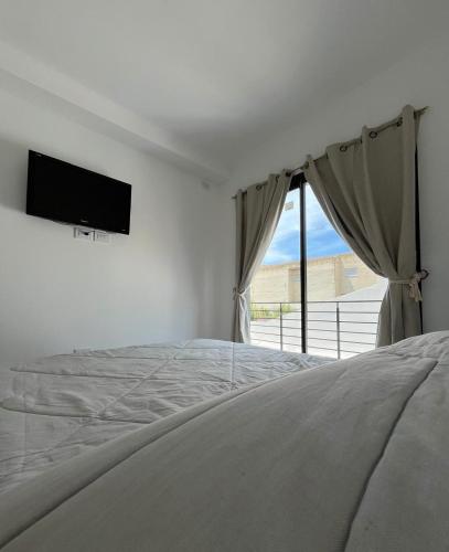 En eller flere senge i et værelse på Dpto SOÑADO Necochea