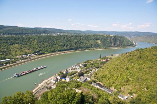 a river with a group of boats in the water at Hotel Rheingraf in Kamp-Bornhofen