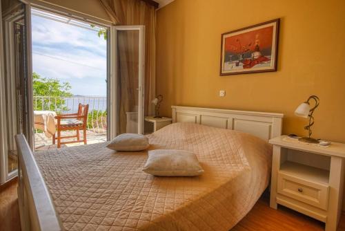 a bedroom with a bed with two pillows on it at Helena in Mlini