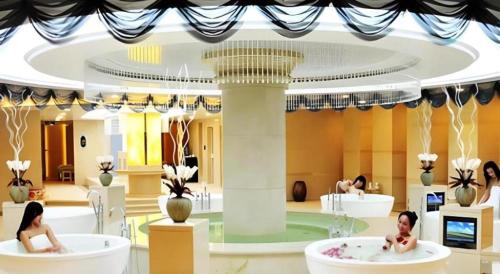 two women sitting in bath tubs in a building at Metropark Hotel in Huludao