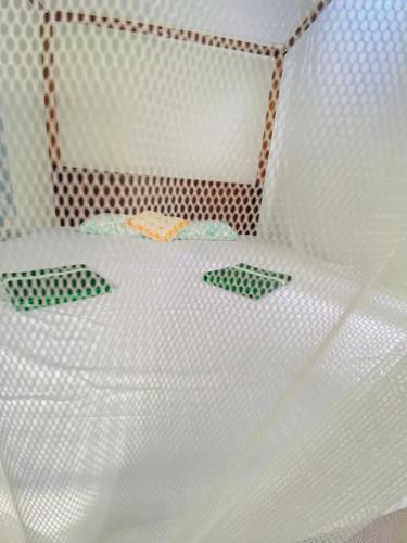 a white bed with two green plates on it at Talalla Wonder View in Talalla South