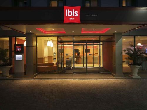 a building with a sign on the front of it at Ibis Lagos Ikeja in Ikeja