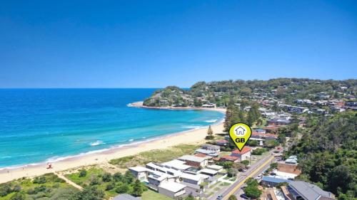an aerial view of a beach with a speed limit sign at Elanora 3 - Beachfront Unit With Views! in Avoca Beach