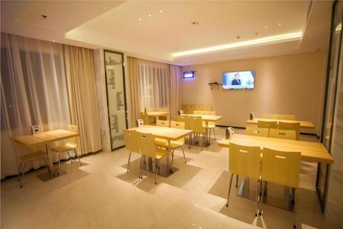 een vergaderruimte met tafels en stoelen en een tv bij City Comfort Inn Huaihua Tunnel Bus Station in Tongdao