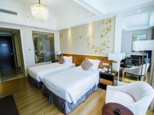 Ένα ή περισσότερα κρεβάτια σε δωμάτιο στο Ming Guan Hotel