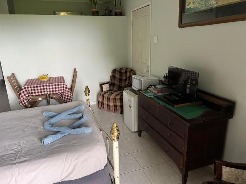 a bedroom with a bed and a desk with a computer at Mission Beach Escape BnB in South Mission Beach