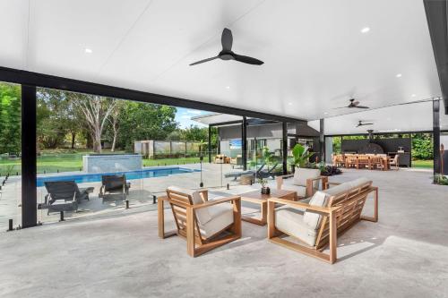 an open living room with a pool and furniture at Racecourse Resort in Darawank