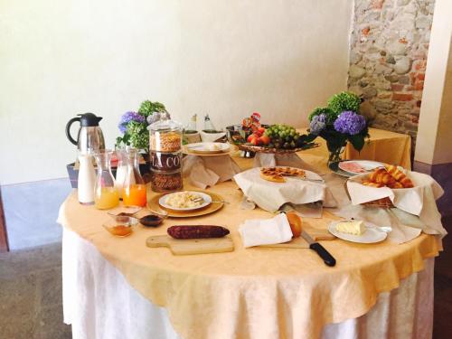 a table with food and drinks on it at Le 5 Frecce in Cavour