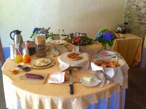 a table topped with food and plates of food at Le 5 Frecce in Cavour