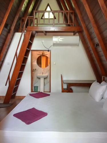 a bedroom with a large bed with a staircase at Rock Pool Residence in Tangalle