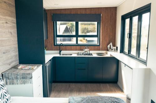 a kitchen with a sink and a window at Map Of Africa Ocean View Tiny House in Wilderness