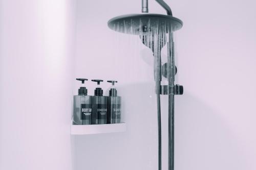 a shower with three bottles on a shelf at Compact Loft 9 Studio 001 with Gym Namba in Wada