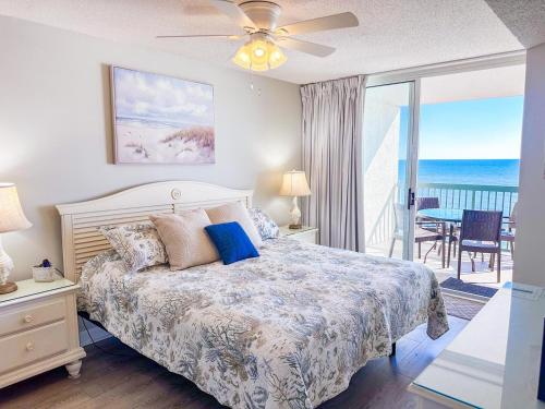 a bedroom with a bed and a view of the ocean at Ashworth 905 in North Myrtle Beach