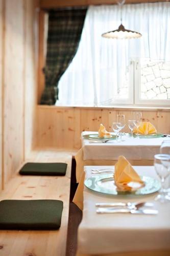 a dining room with two tables and a plate of food at Parc Hotel Miramonti in Fiè