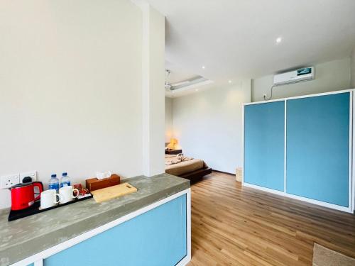 a kitchen with a blue cabinet in a room at Hello Mirissa in Mirissa