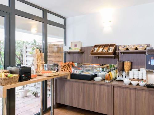 a kitchen with a counter with food on it at Aparthotel Adagio Access Paris Clamart in Clamart