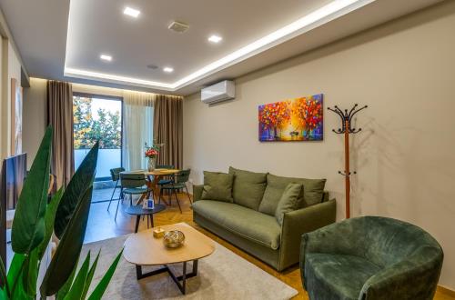 a living room with a couch and a table at Pantio Living Residence in Meneou