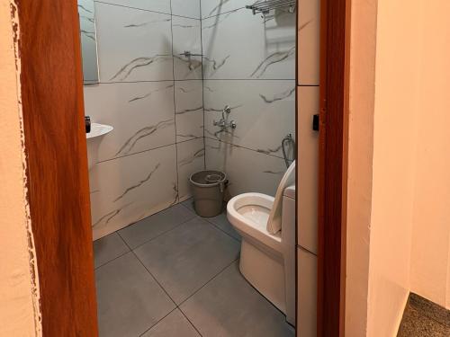 a bathroom with a toilet and a shower at Sandcastle Resort in Varkala