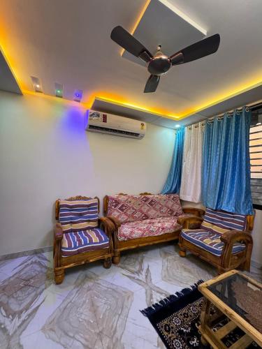a living room with a couch and a ceiling fan at Vijay Cozy Corner Hostel in Navi Mumbai