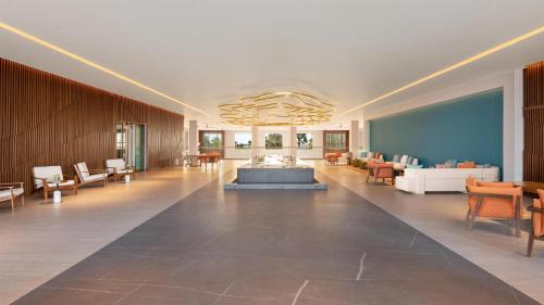 a large room with a lobby with chairs and a table at Dreams Puerto Morelos Resort & Spa - All Inclusive in Puerto Morelos