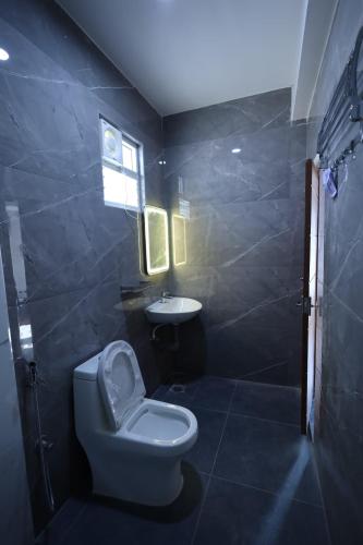 a bathroom with a toilet and a sink at KK Service Suites in Coimbatore