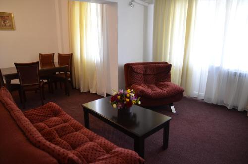 a living room with a couch and chairs and a table at Hotel Europolis in Tulcea