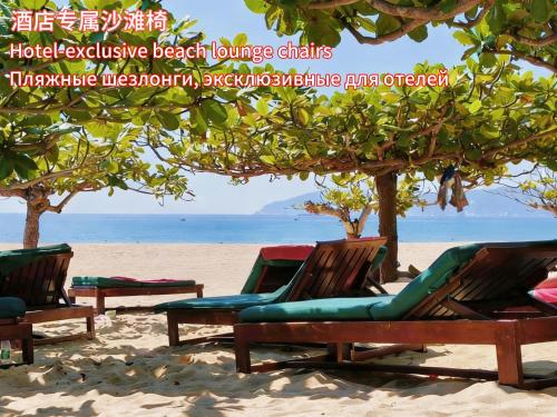 a group of lounge chairs on the beach at Horizon Resort & Spa Yalong Bay-Yalong Bay Central in Sanya