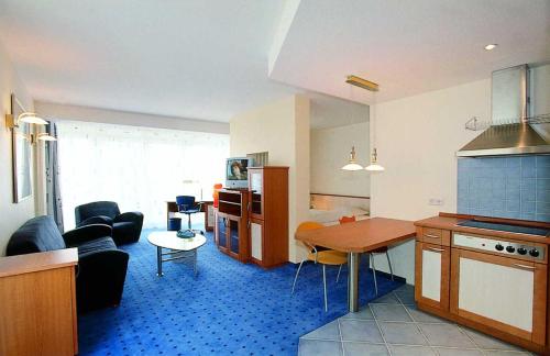 a kitchen and living room with a couch and a table at Appart-Hotel-Heldt in Bremen