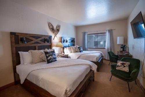 a hotel room with two beds and a chair at Relaxing Double Queen Mountain Getaway Near Park City & Sundance Ski Resorts - 2066 in Mound City