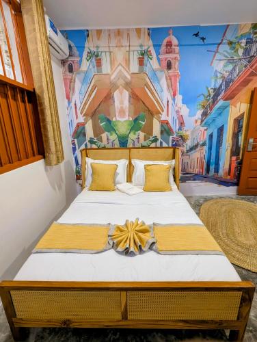 a bedroom with a bed with a painting on the wall at Bellimena Stone Town in Zanzibar City