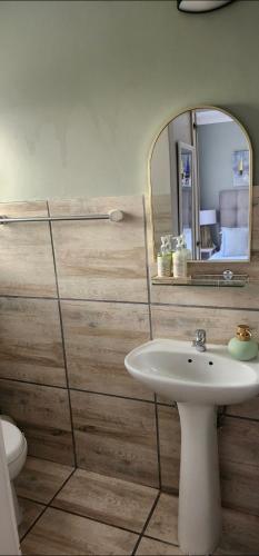 a bathroom with a sink and a mirror at Sunset Heights 23 Coastal Sanctuary in Langebaan
