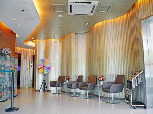 a waiting room with chairs and a table in a building at Jinjiang Inn Baoding Military School Square in Baoding