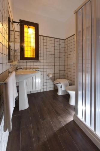 a bathroom with two sinks and two toilets at Borgo Medievale in Castelmola