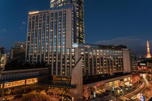 a large building with lights on in a city at night at Grand Hyatt Tokyo in Tokyo